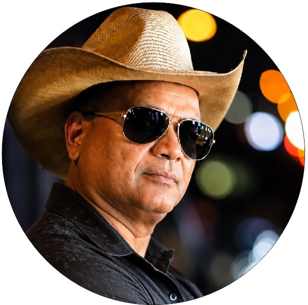 Close-up portrait of Vipul C. Patel in a cowboy hat and aviator sunglasses