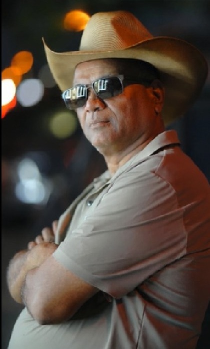 Earlier photograph of Vipul C. Patel in a cowboy hat and sunglasses